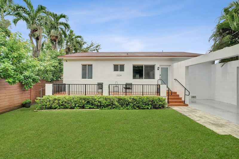 White one-story home with a railed front terrace and steps