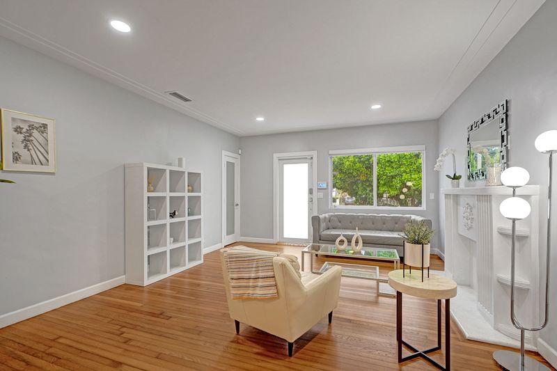 Living room with wood floors and a garden window