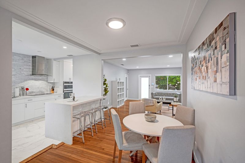 Dining area and kitchen with breakfast bar seating