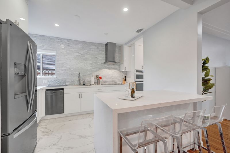 Kitchen with a stainless refrigerator and breakfast bar