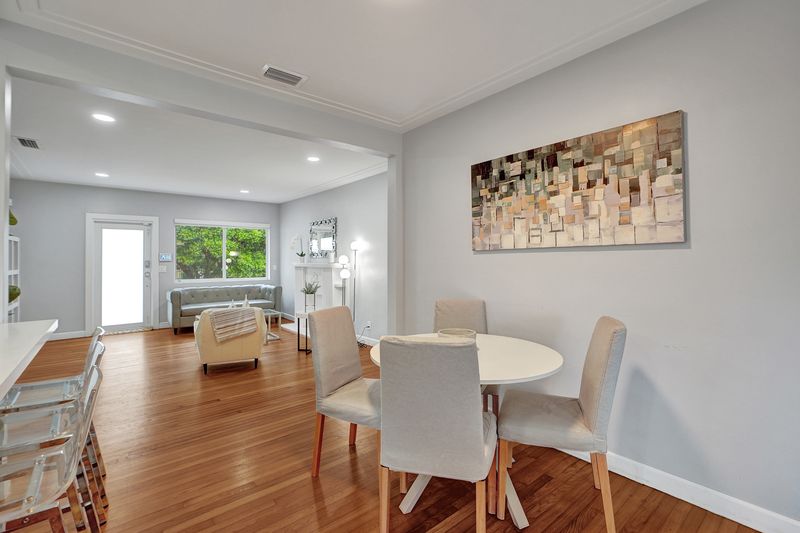Dining area with wood floors and a window to the yard