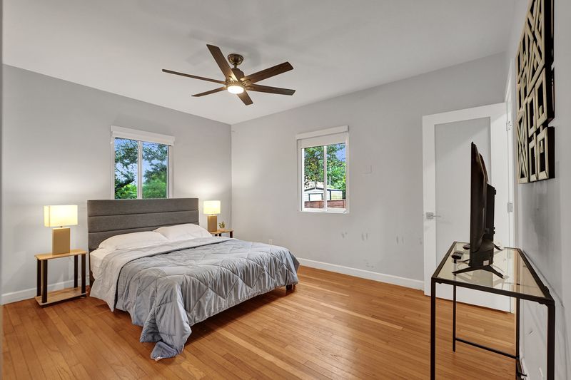 Bedroom with wood floors and a ceiling fan