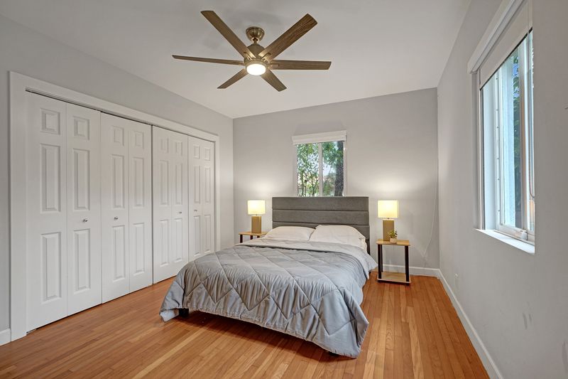 Bedroom with double closet doors and a ceiling fan