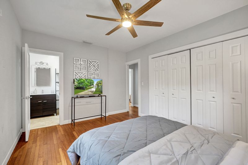 Bedroom with a closet and door to the bath