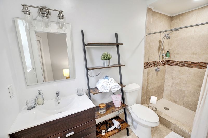 Bathroom vanity and tiled shower