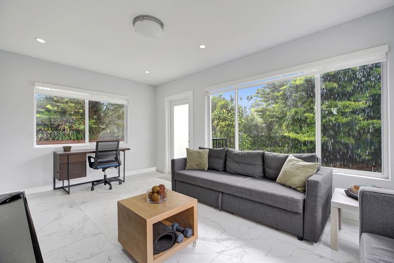 Florida room with large windows to the backyard and tile floors