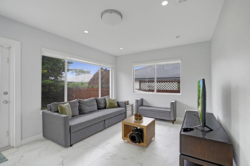 Florida room seating area with windows to the yard