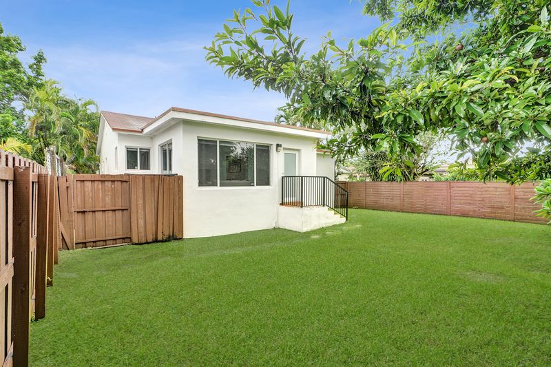Rear of the home and fenced backyard