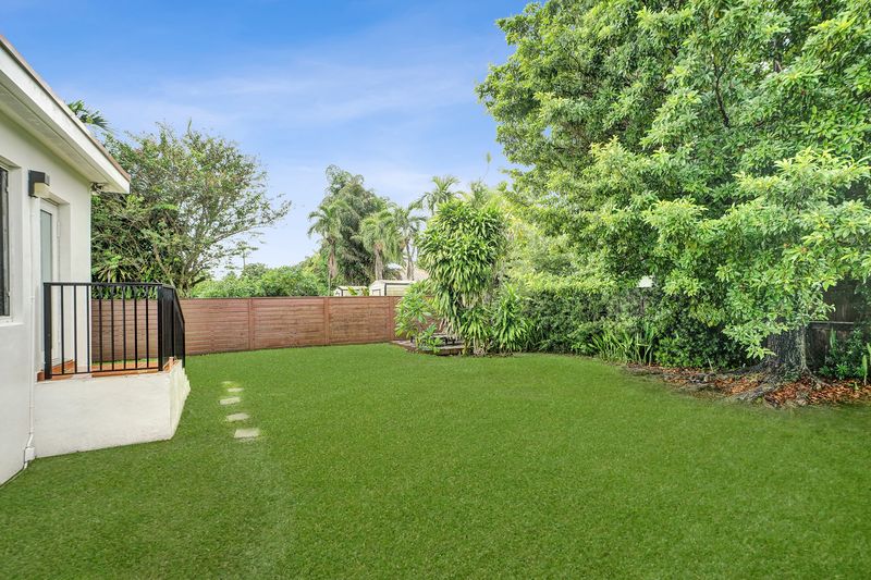 Side of the home and the backyard lawn