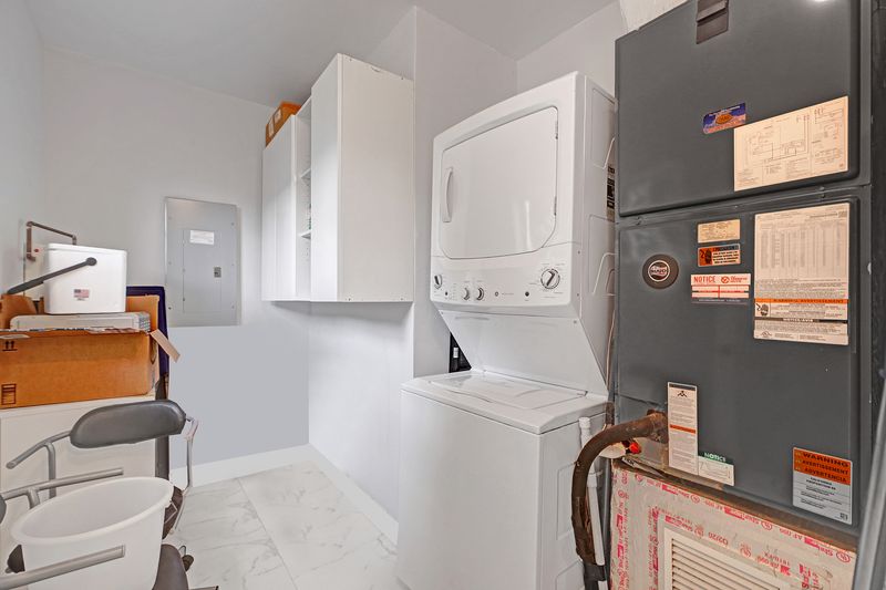 Laundry room with a stacked washer and dryer