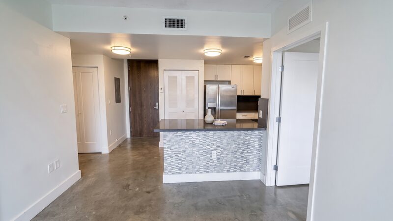 Open kitchen and living area with impact glass in a unit at 4332 W Flagler Street