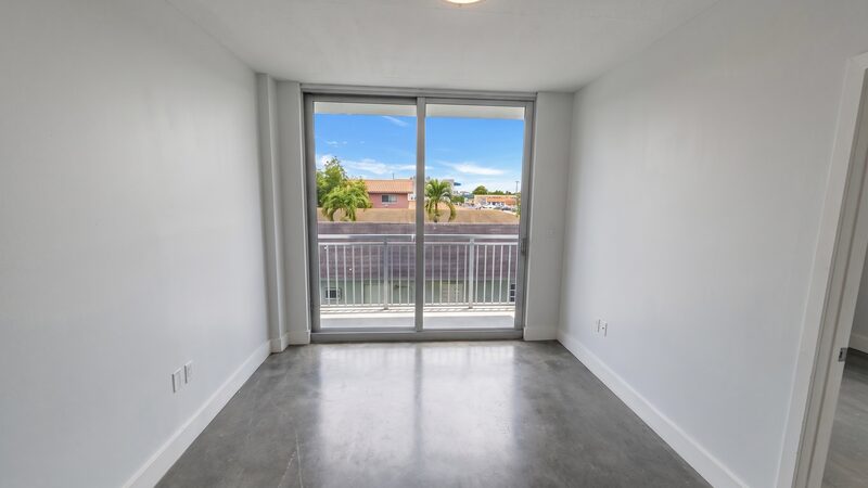Impact-glass sliders and private balcony in a unit at 4332 W Flagler Street