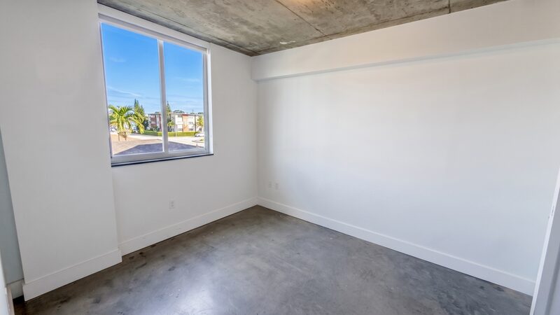 Bedroom with an impact window in a unit at 4332 W Flagler Street