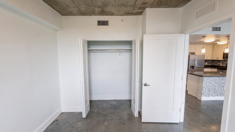 Unit interior with a closet and the kitchen beyond at 4332 W Flagler Street