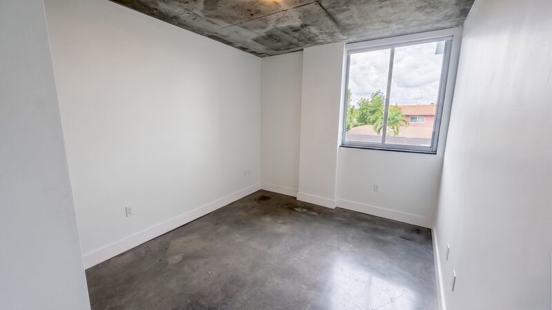 Bedroom with polished concrete floor in a unit at 4332 W Flagler Street