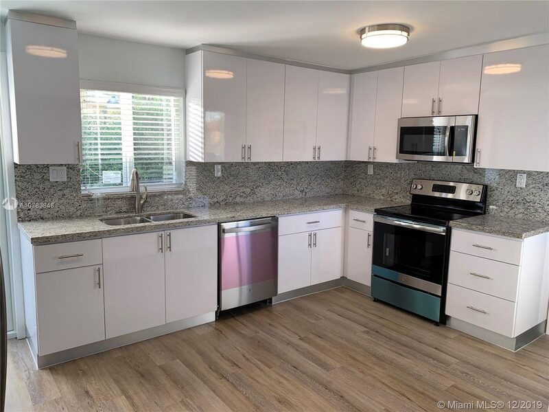 Renovated kitchen with white cabinetry and stainless appliances at 4331 SW 1st Street