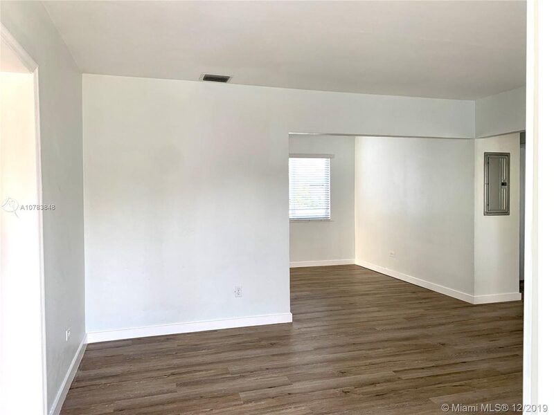 Open living area with wood-look floors at 4331 SW 1st Street
