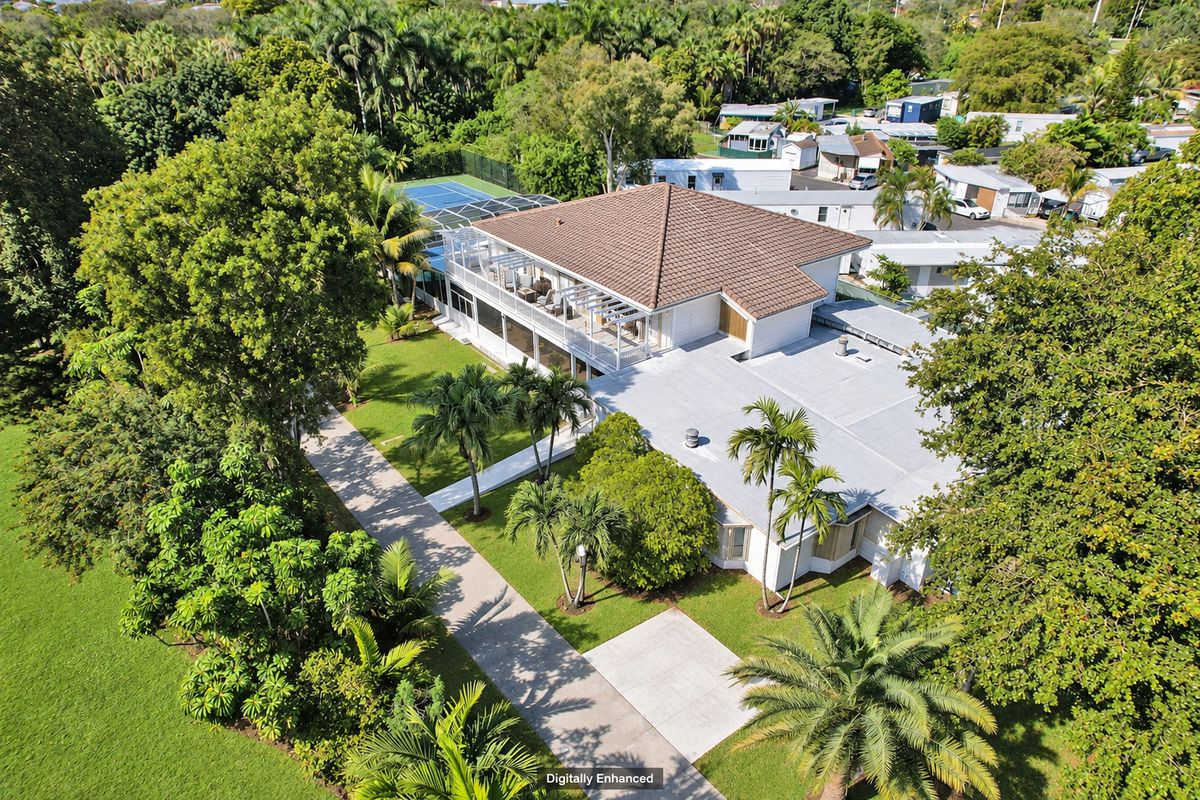Aerial view of 4755 SW 73rd Ave in Davie with the pool enclosure and tennis court, digitally enhanced