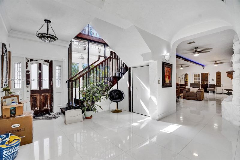 Entry with double front doors and a wood staircase