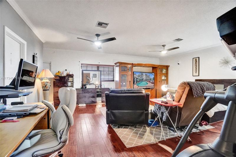 Bedroom suite with wood floors and a sitting area
