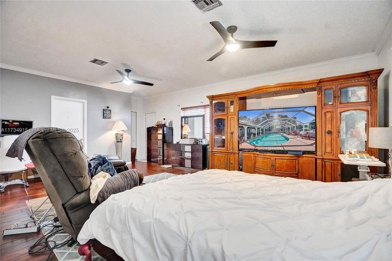 Bedroom with a built-in wood entertainment center