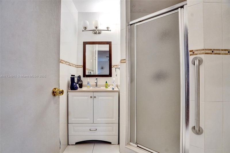 Bathroom with a shower stall and single vanity
