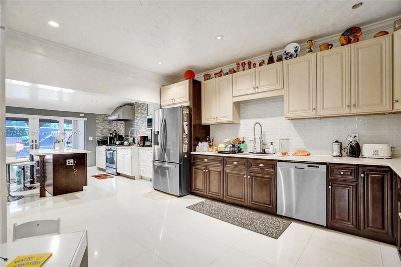 Kitchen with dark wood cabinets and stainless appliances