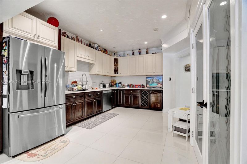 Kitchen with a French-door refrigerator and dark cabinets