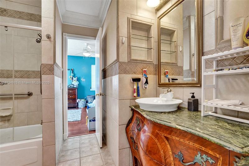 Bathroom with a carved wood vanity and a tub