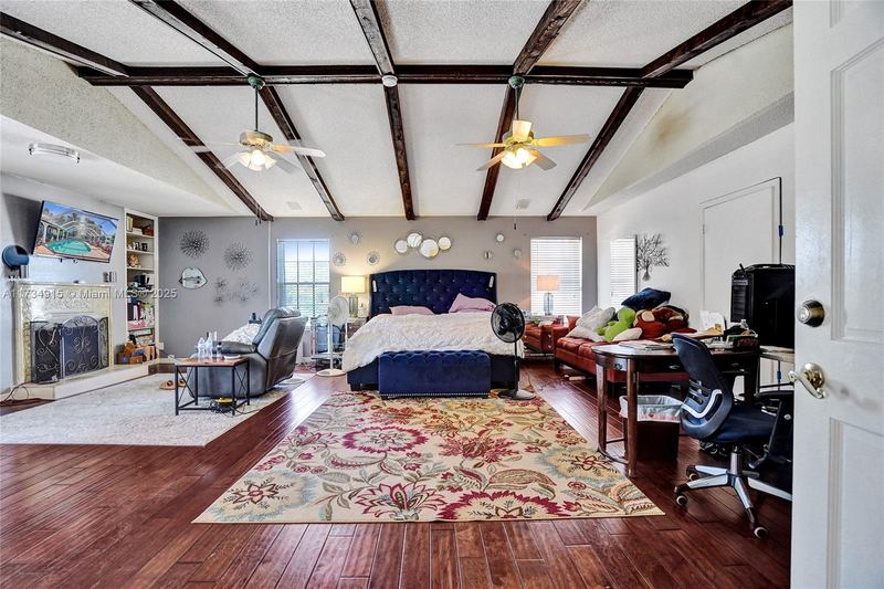 Primary suite with a beamed ceiling and fireplace