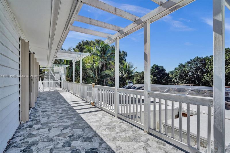 Upstairs balcony with a pergola