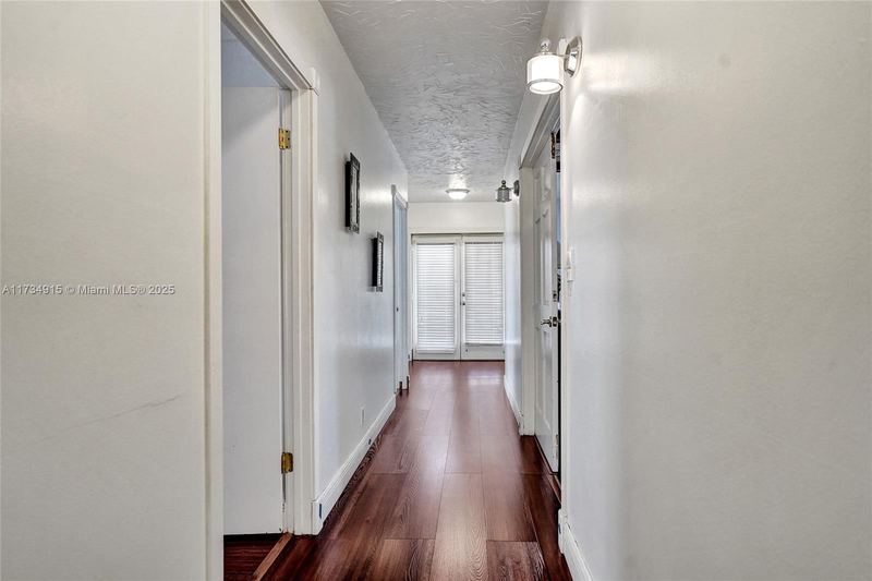 Hallway with wood floors and French doors
