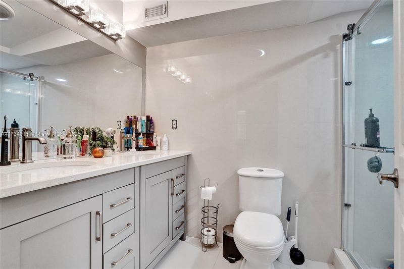 Bathroom with a white vanity and glass shower