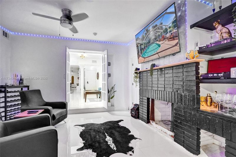 Den with a black brick fireplace