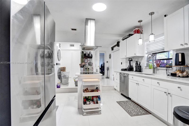 Second kitchen with an island and range hood