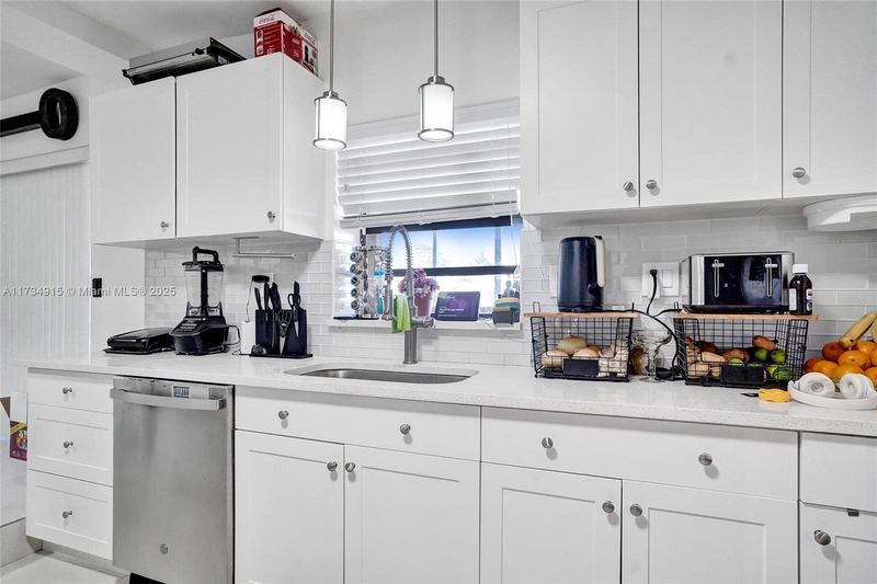 Second kitchen with white shaker cabinets