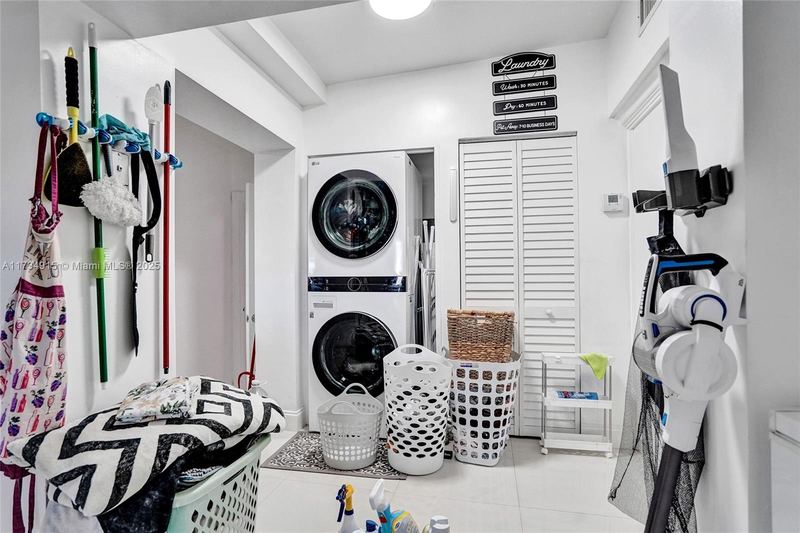 Laundry room with a stacked washer and dryer