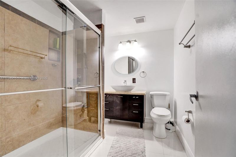 Bathroom with a glass shower and vessel sink
