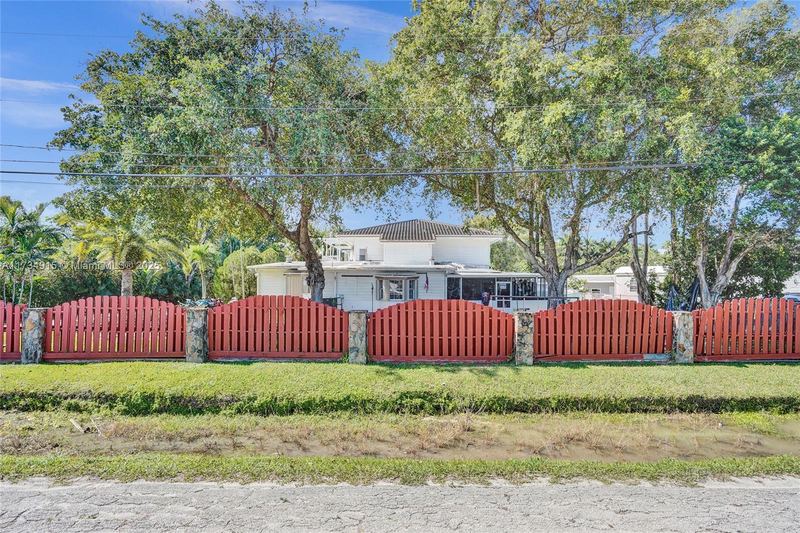 Front of the property behind a wood fence