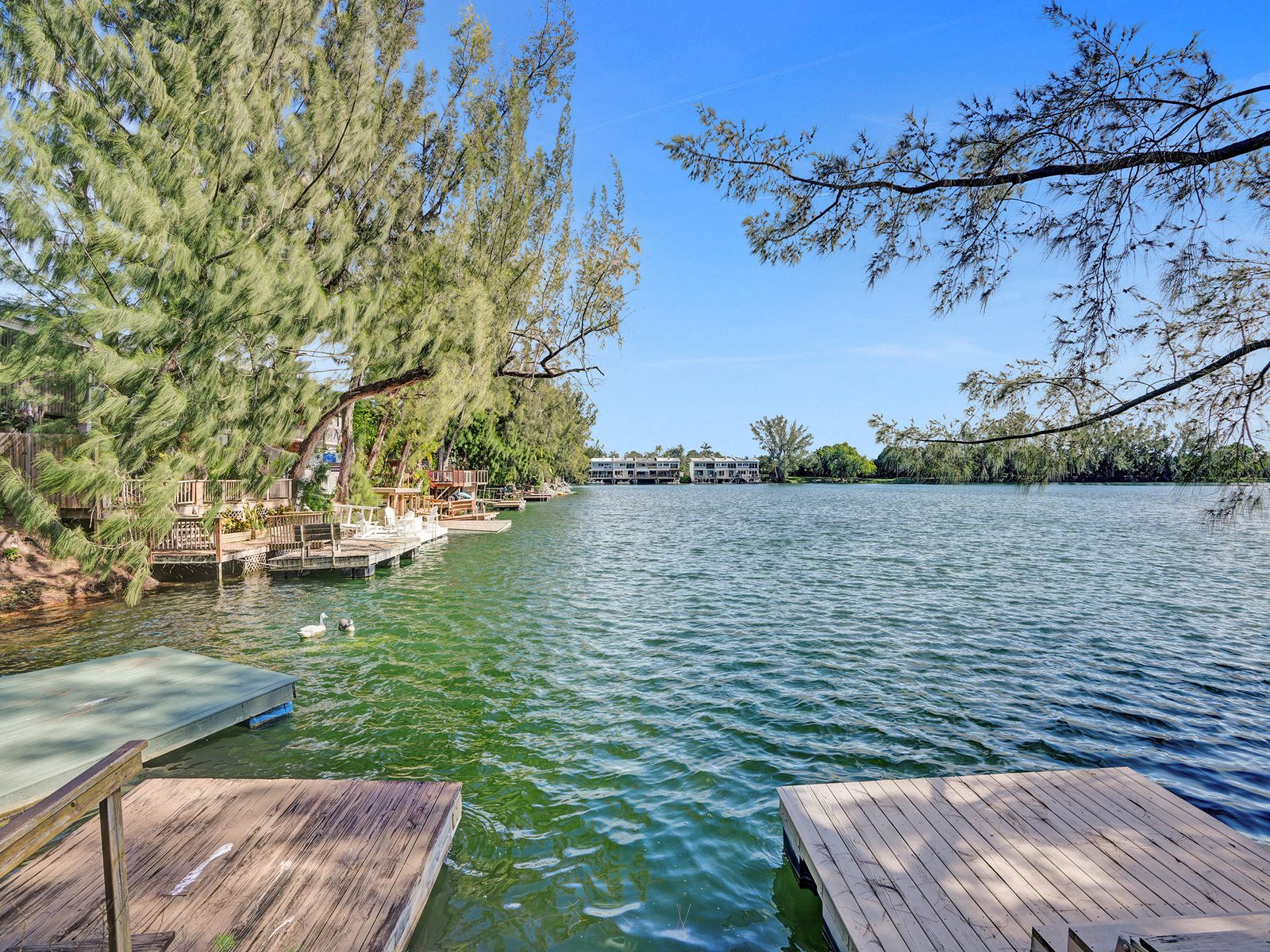 Private dock and open-water view of the 22-acre lake behind 4863 SW 71st Place in Glenvar Heights, Miami