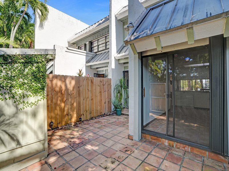 Rear screened patio with impact-glass sliders at 4863 SW 71st Place, Miami