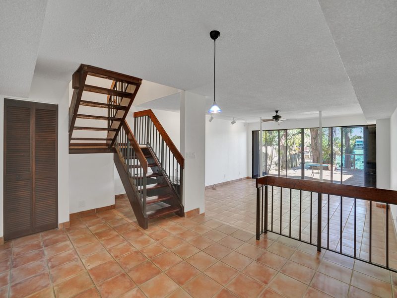 Living area with staircase at 4863 SW 71st Place, Miami