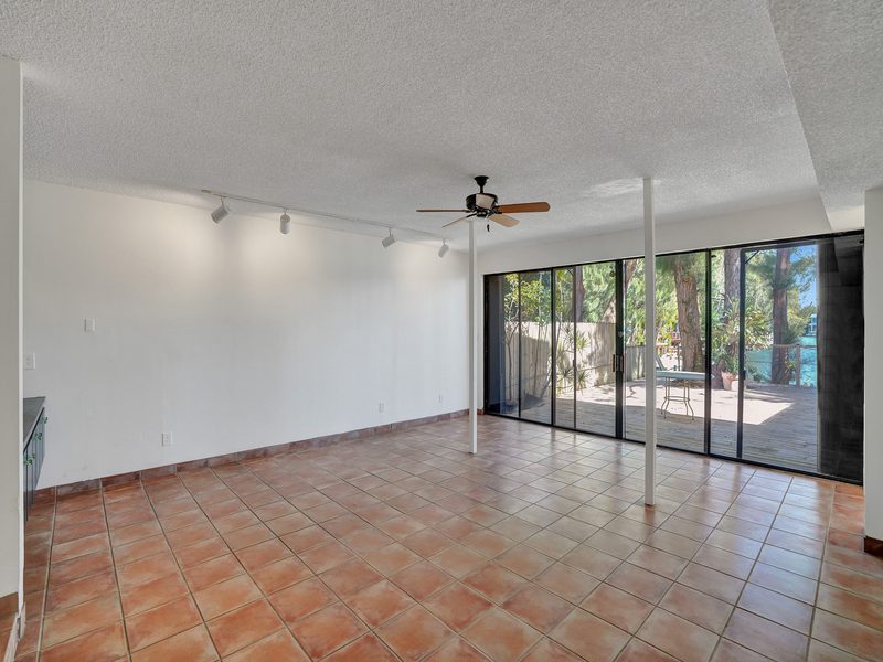 Living room with sliders to the greenery at 4863 SW 71st Place, Miami