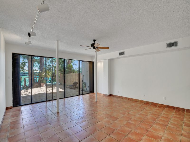 Living area with wood floors and a beam ceiling at 4863 SW 71st Place, Miami
