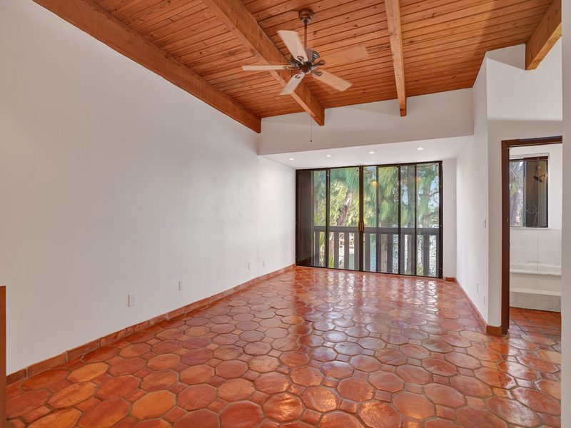 Living area with sliders and a beam ceiling at 4863 SW 71st Place, Miami