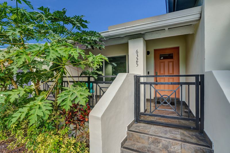 Front steps and gated entry with the house number
