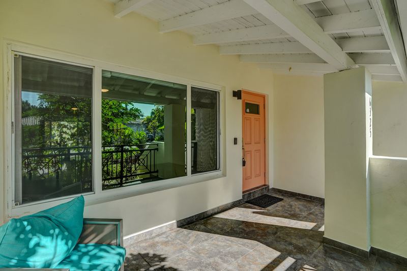 Front porch with large windows and a tile floor