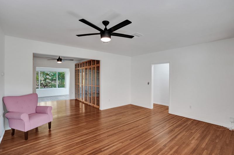 Living room opening to the hall of built-in bookcases