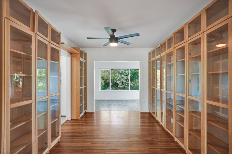 Hall lined with built-in glass-front bookcases