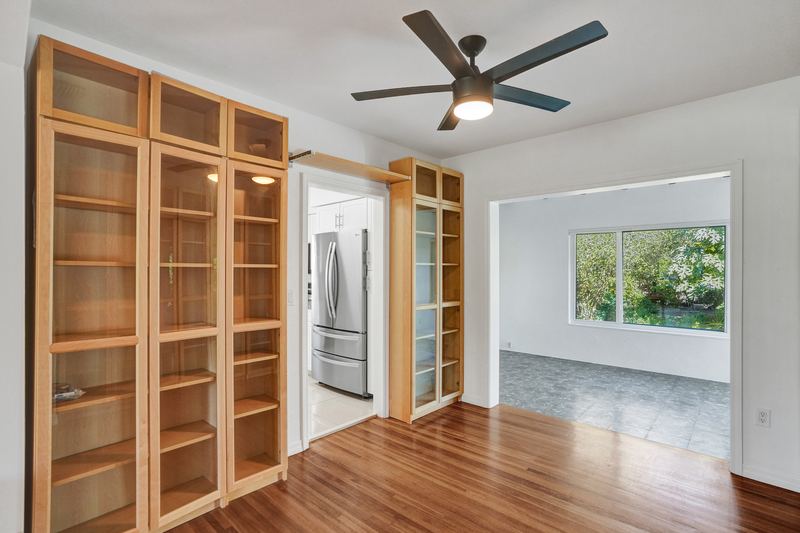 Built-in bookcases with views into the kitchen and back room